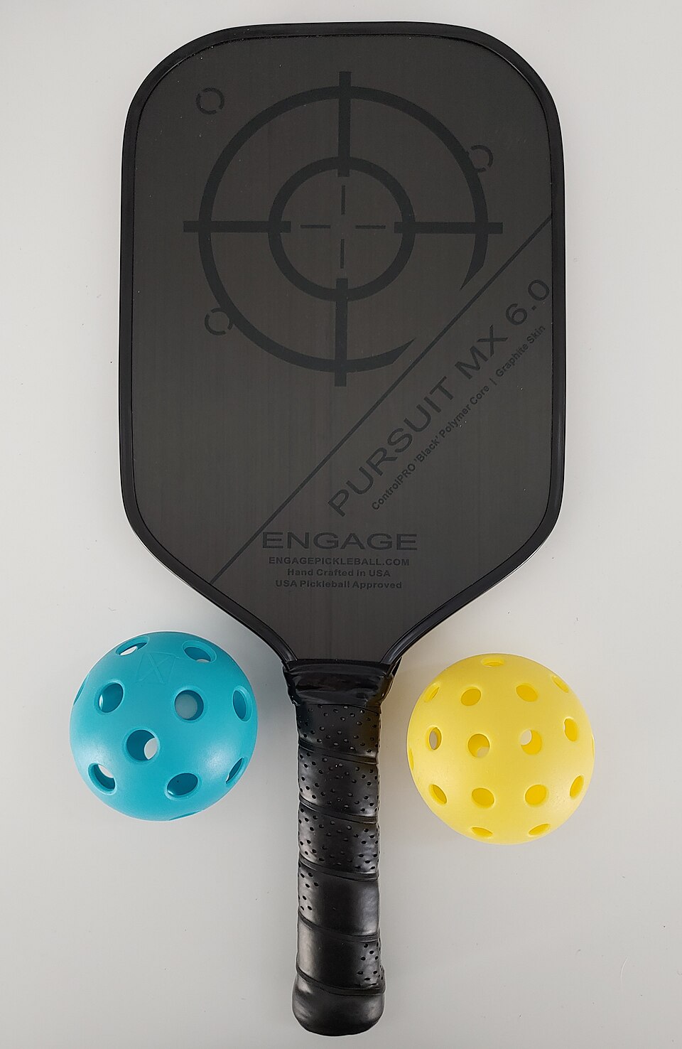 Sample photo: a pickleball paddle with two balls