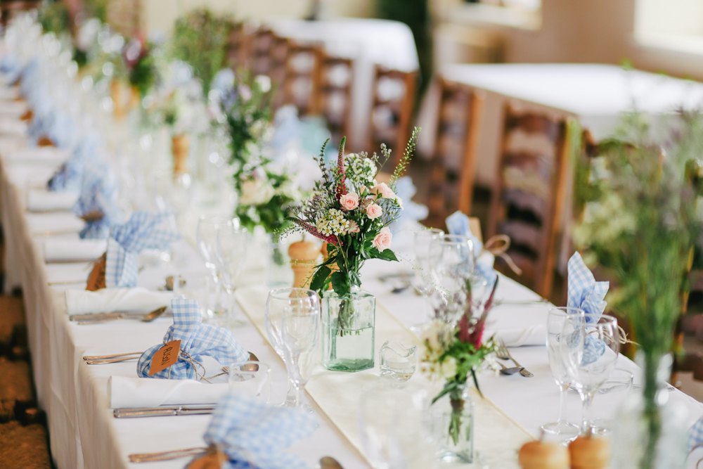 Sample photo: a long, flower-lined wedding reception table