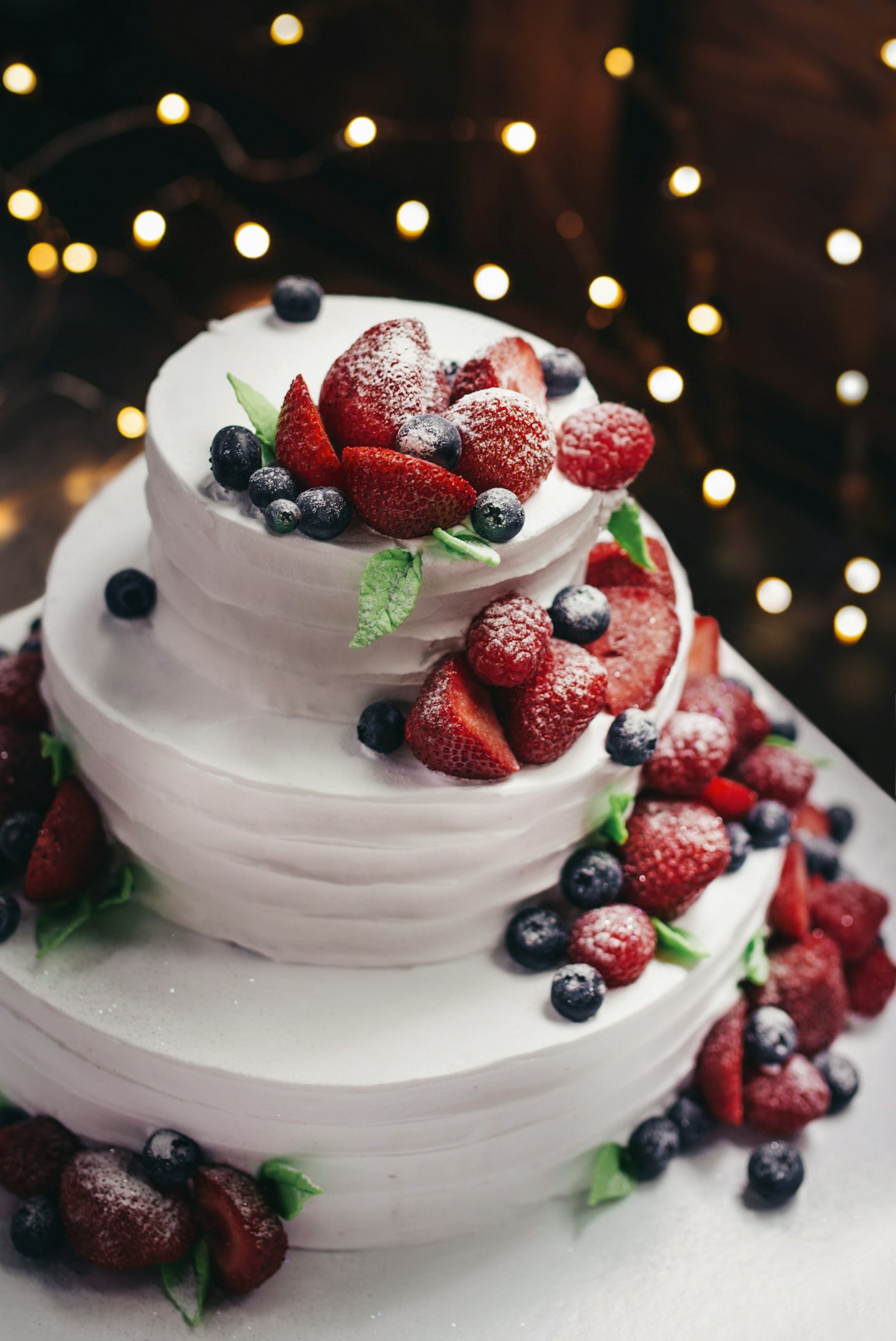 Sample photo: a white layered cake topped with strawberries and blueberries